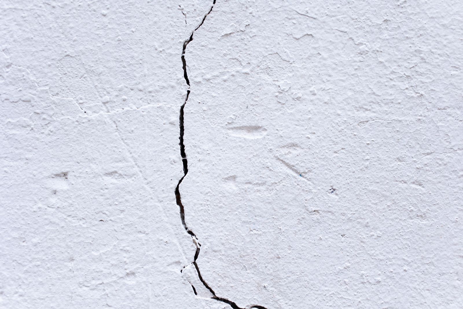 Close-up of a weathered cracked surface showing material degradation