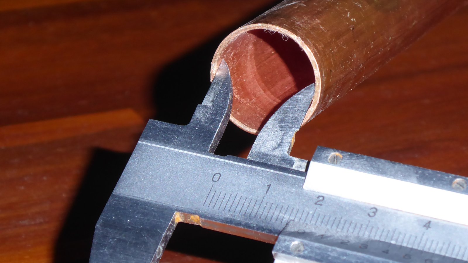 Caliper checking the inside diameter of a part